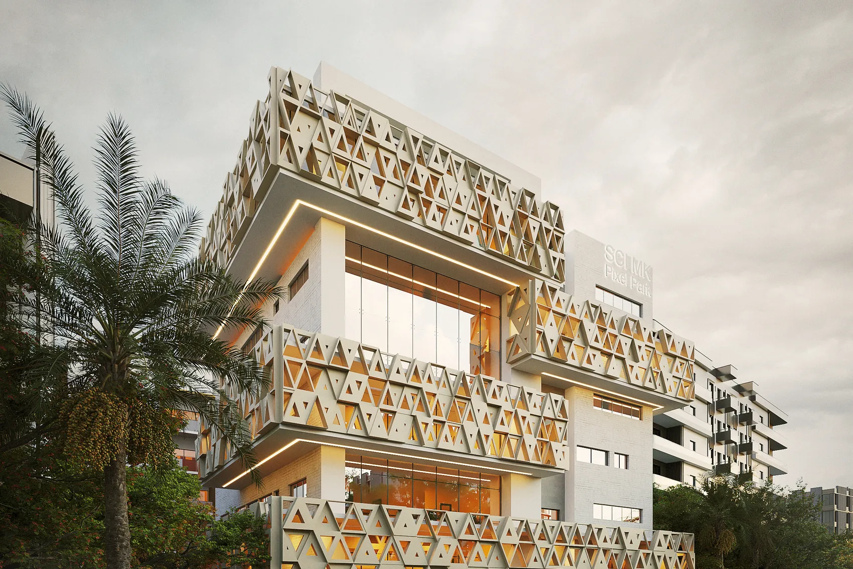 Immeuble aux façades habillées de modules triangulaires ajourés, éclairé au crépuscule